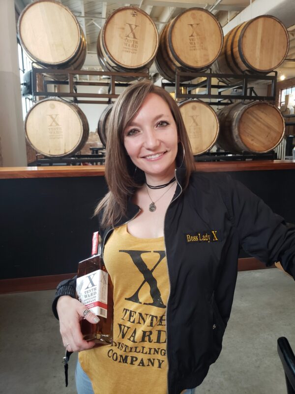 Monica Pearce, owner at Tenth Ward a woman-owned distillery holding Maryland Rye Whiskey bottle