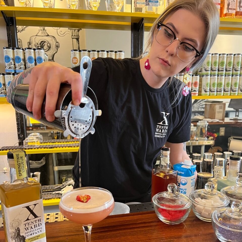 Tenth Ward cocktail bar and tasting room mixologist pouring a drink